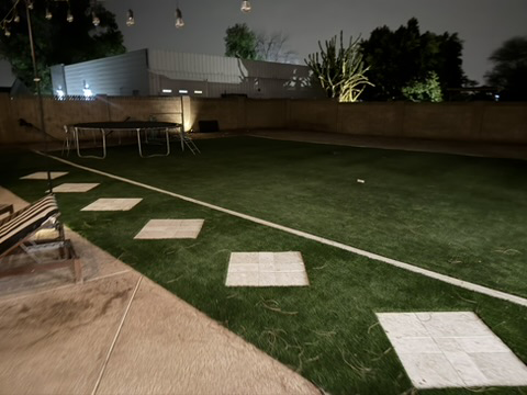 Finished artificial turf backyard at night